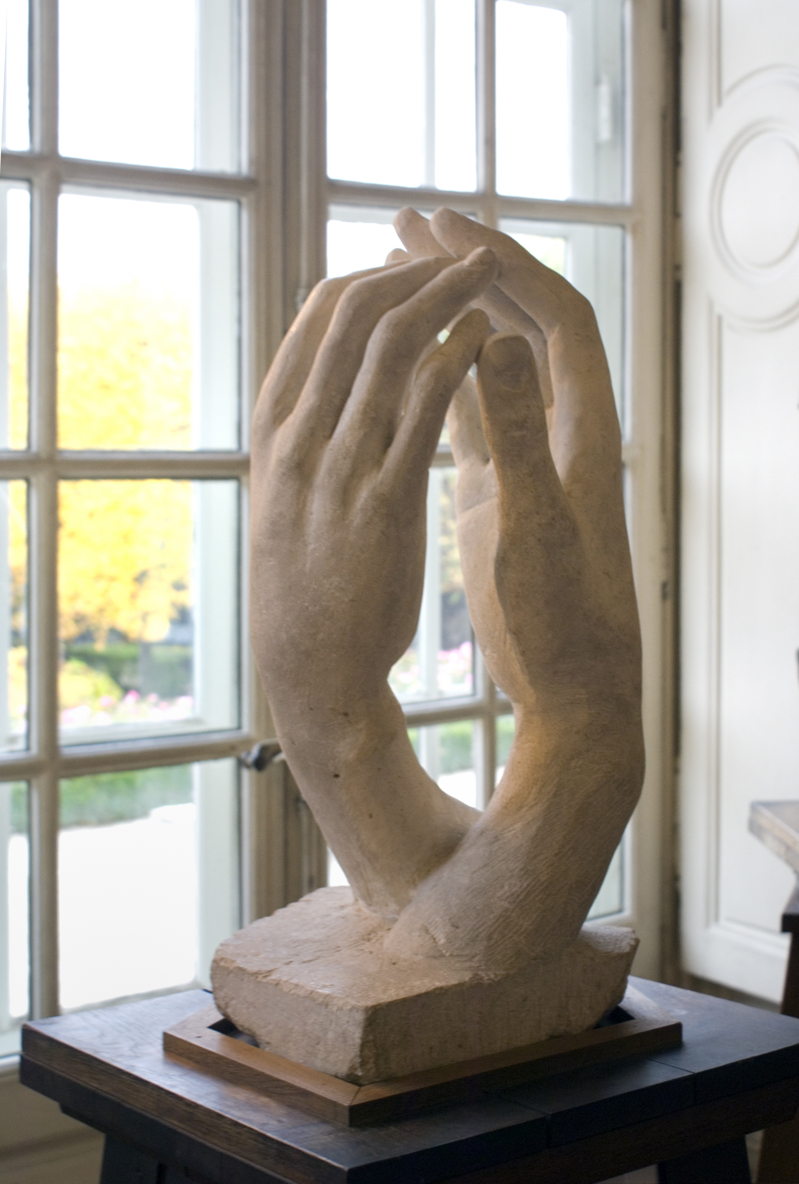 Two sculpted hands reaching toward one another in Auguste Rodin's The Cathedral